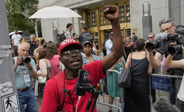 A supporter of Sean "Diddy" Combs, reacts outside Manhattan federal court after Combs' was convicted of a prostitution-related offense but acquitted on the most serious charges at his New York trial, Wednesday, July 2, 2025, in New York. (AP Photo/Yuki Iwamura)