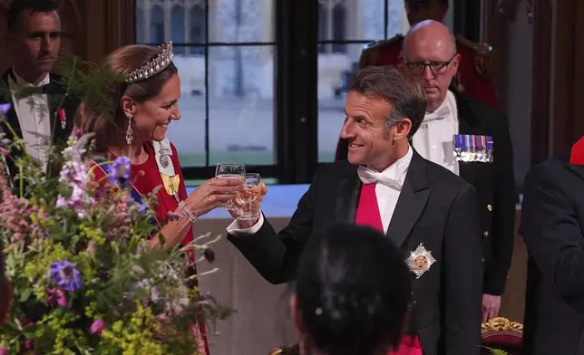 Britain's Kate, Princess of Wales, left, and President of France Emmanuel Macron, right, attend a State Banquet at Windsor Castle, in Windsor, England, Tuesday, July 8, 2025. (Yui Mok/Pool Photo via AP)