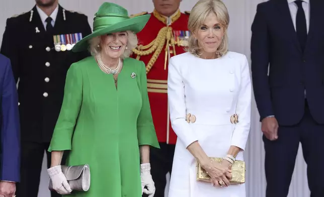 Britain's Queen Camilla, left, welcomes Brigitte Macron, wife of France's President Emmanuel Macron, in Windsor, England, Tuesday July 8, 2025, on the first day of a three-day state visit to Britain. (Chris Jackson/Pool via AP)