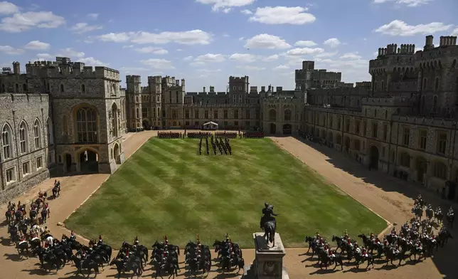 The Royal Guards take part in a welcome ceremony for French President Emmanuel Macron and his wife Brigitte Macron at Windsor Castle in Windsor, England, Tuesday July 8, 2025, on the first day of a three-day state visit to Britain. (Jaimi Joy/Pool via AP)