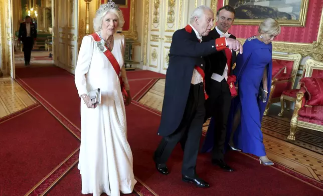 Britain's Queen Camilla, from left, King Charles III with France's President Emmanuel Macron and wife Brigitte attend the State Banquet at Windsor Castle in Windsor, England, Tuesday, July 8, 2025. (Chris Jackson/Pool Photo via AP)