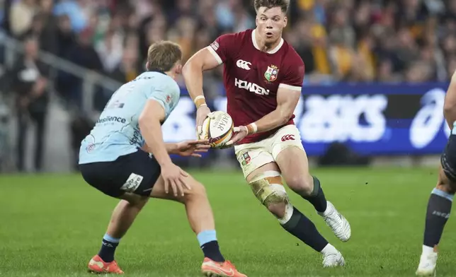 Huw Jones of the British &amp; Irish Lions runs at Waratahs' Joey Walton during the Lions and Waratahs rugby match in Sydney, Australia, Saturday, July 5, 2025. (AP Photo/Mark Baker)