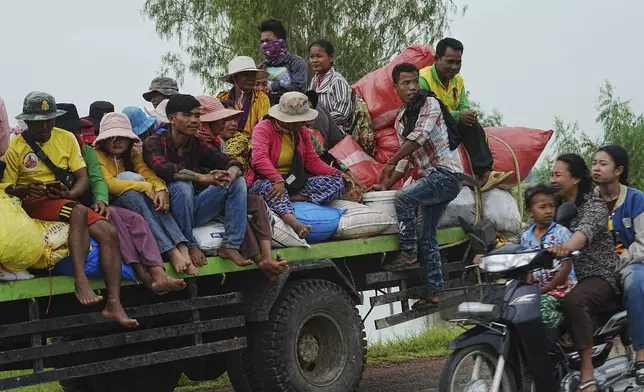 Cambodians sit on a cart of a tractor as they take refuge in Oddar Meanchey province, Cambodia, Saturday, July 26, 2025. (AP Photo/Heng Sinith)