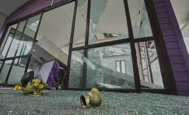 A door of Phanom Dong Rak hospital is damaged after Cambodia fired artillery shells in Surin Province, Thailand, Friday, July 25, 2025. (AP Photo/Sakchai Lalit)