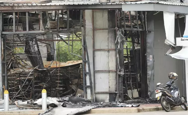 A convenience store at a gas station is damaged after Cambodia fired artillery shells in Sisaket province, Thailand, Friday, July 25, 2025. (AP Photo/Sakchai Lalit)