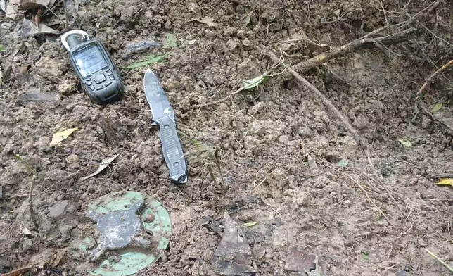In this photo released by the Royal Thai Army, items litter the ground as Thai soldiers inspect a border area on Sunday, July 20, 2025, in Ubon Ratchathani province, where the Royal Thai Army said two anti-personnel landmines were found. (Royal Thai Army via AP)