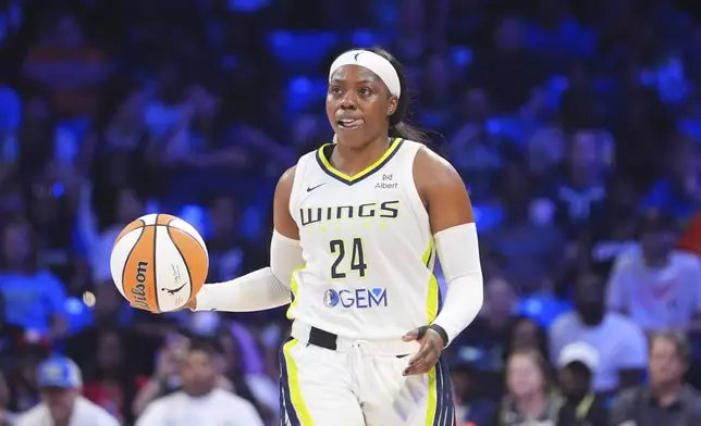 Dallas Wings guard Arike Ogunbowale dribbles during the second half of a WNBA basketball game against the New York Liberty in Arlington, Texas, Monday, July 28, 2025. (AP Photo/LM Otero)