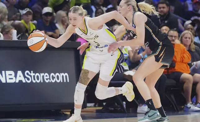 Dallas Wings guards Paige Bueckers (5) is fouled by New York Liberty guard Marine Johannes, right, during the second half of a WNBA basketball game in Arlington, Texas, Monday, July 28, 2025. (AP Photo/LM Otero)