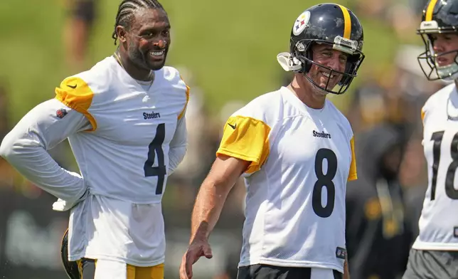 Pittsburgh Steelers quarterback Aaron Rodgers (8) and wide receiver D.K. Metcalf (4) smile during practice at the team’s NFL football training camp in Latrobe, Pa., Thursday, July 24, 2025. (AP Photo/Gene J. Puskar)