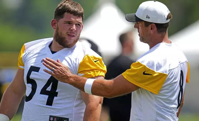 Pittsburgh Steelers quarterback Aaron Rodgers, right, talks with center Zach Frazier (54) during practice at the team’s NFL football training camp in Latrobe, Pa., Thursday, July 24, 2025. (AP Photo/Gene J. Puskar)
