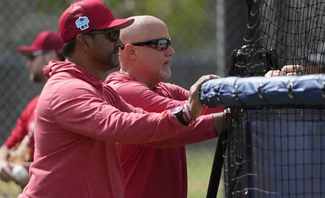 FILE - Washington Nationals manager Dave Martinez, left, watches with general manager Mike Rizzo during spring training baseball practice Saturday, Feb. 18, 2023, in West Palm Beach, Fla. (AP Photo/Jeff Roberson, File)