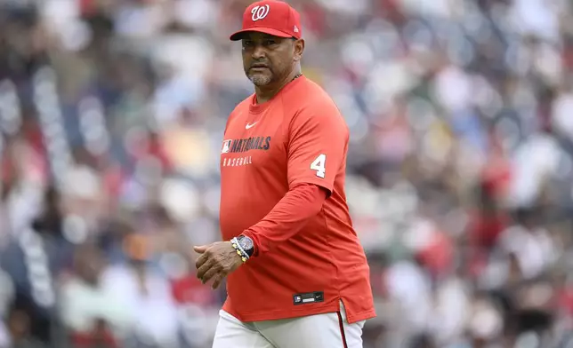 Washington Nationals manager Dave Martinez walks back to the dugout after a pitching change during the eighth inning of a baseball game against the Boston Red Sox, Sunday, July 6, 2025, in Washington. (AP Photo/Nick Wass)