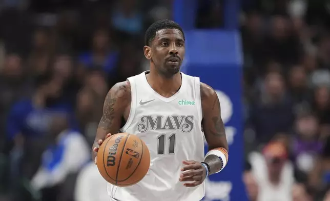 FILE - Dallas Mavericks guard Kyrie Irving advances the ball up court during an NBA basketball game against the Milwaukee Bucks in Dallas, Saturday, March 1, 2025. (AP Photo/Tony Gutierrez,File)