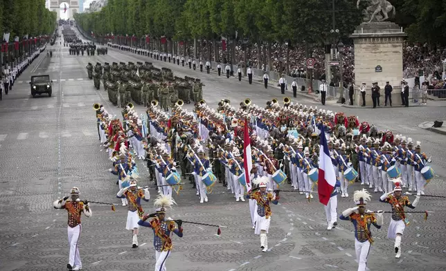 Indonesian troops march on the Champs-Elysees avenue during the Bastille Day parade, Monday, July 14, 2025 in Paris. (AP Photo/Christophe Ena)