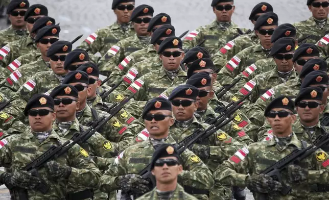 Indonesian troops march on the Champs-Elysees avenue during the Bastille Day parade, Monday, July 14, 2025 in Paris. (AP Photo/Christophe Ena)
