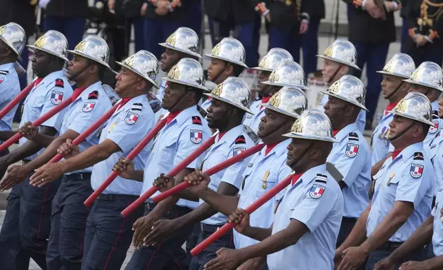 Members of the Civil Security march during the Bastille Day parade, Monday, July 14, 2025 in Paris. (AP Photo/Michel Euler)