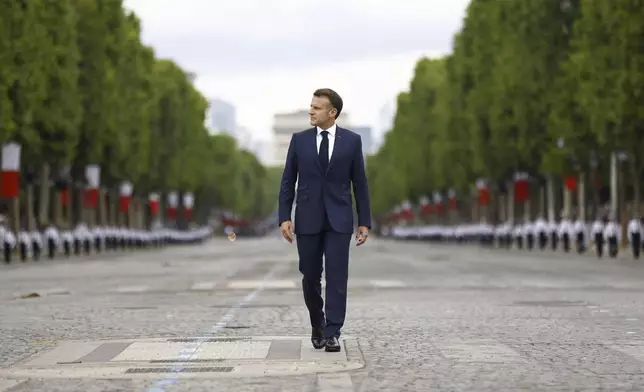 French President Emmanuel Macron arrives to the Bastille Day military parade on the Champs-Elysees avenue, Monday July 14, 2025. (Mohammed Badra, Pool via AP)