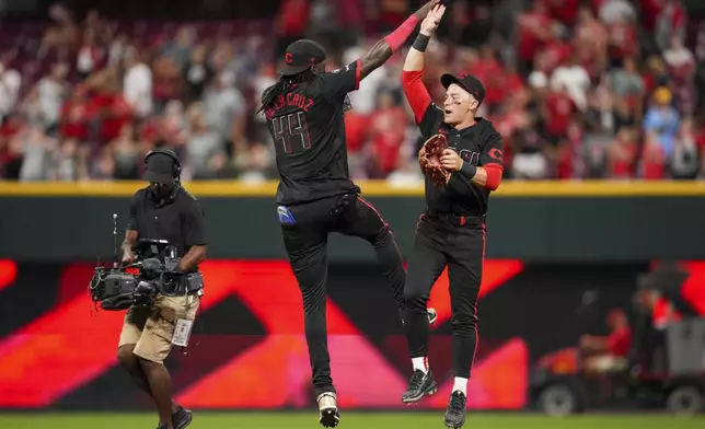 Cincinnati Reds' Elly De La Cruz (44) celebrates with teammate TJ Friedl following a baseball game against the Tampa Bay Rays, Friday, July 25, 2025, in Cincinnati. (AP Photo/Jeff Dean)