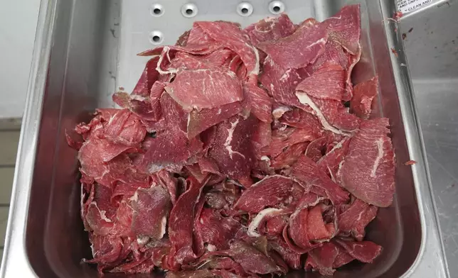 Thinly sliced strips of beef set in a tray for cheesesteaks in a tray at Jim's South St. in Philadelphia, Wednesday, July 23, 2025. (AP Photo/Matt Rourke)