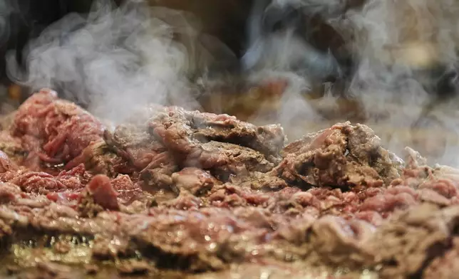 Beef slices for cheesesteaks are being cooked at Jim's South St. in Philadelphia, Wednesday, July 23, 2025. (AP Photo/Matt Rourke)