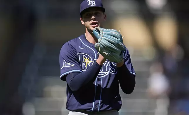 Tampa Bay Rays relief pitcher Eric Orze claps after forcing the final out to defeat the Minnesota Twins in 10 innings of a baseball game Sunday, July 6, 2025, in Minneapolis. (AP Photo/Abbie Parr)