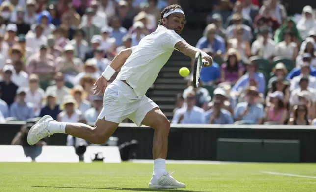 Fabio Fognini of Italy returns to Carlos Alcaraz of Spain during their first round men's singles match at the Wimbledon Tennis Championships in London, Monday, June 30, 2025. (AP Photo/Alastair Grant)