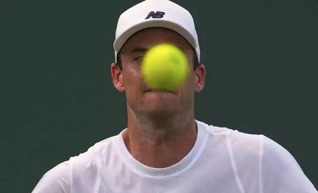 Tommy Paul of the U.S.watches the ball during his first round men's singles match against Johannus Monday of Britain during the Wimbledon Tennis Championships in London, Tuesday, July 1, 2025.(AP Photo/Joanna Chan)