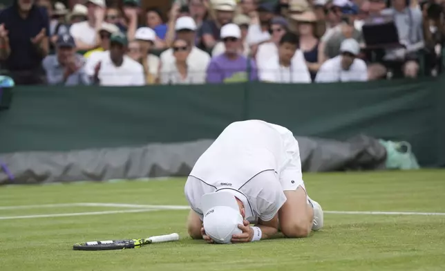 Jesper de Jong of the Netherlands celebrates after beating Christopher Eubanks of the U.S. in their first round men's singles match at the Wimbledon Tennis Championships in London, Tuesday, July 1, 2025. (AP Photo/Alastair Grant)