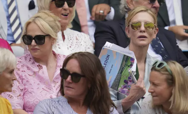 Actors Cate Blanchett, right, and Rebel Wilson sit in the Royal Box on Centre Court on day two at the Wimbledon Tennis Championships in London, Tuesday, July 1, 2025. (AP Photo/Kin Cheung)