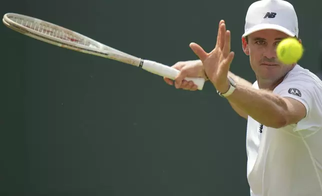 Tommy Paul of the U.S. returns to Johannus Monday of Britain during their first round men's singles match at the Wimbledon Tennis Championships in London, Tuesday, July 1, 2025. (AP Photo/Alastair Grant)