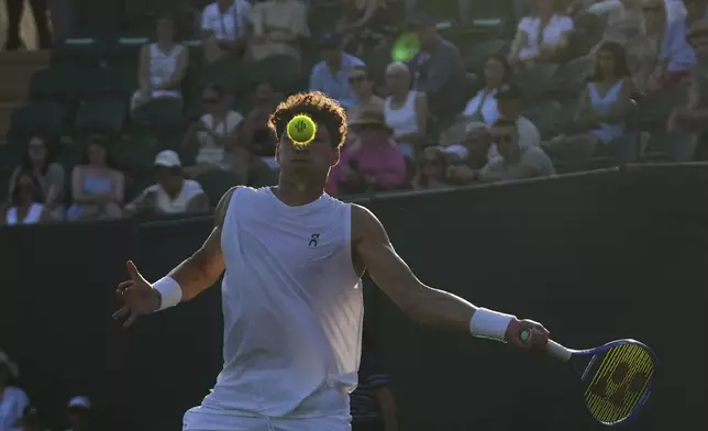 Ben Shelton of the U.S. returns the ball to Alex Bolt of Australia during their first round men's single match at the Wimbledon Tennis Championships in London, Tuesday, July 1, 2025.(AP Photo/Joanna Chan)