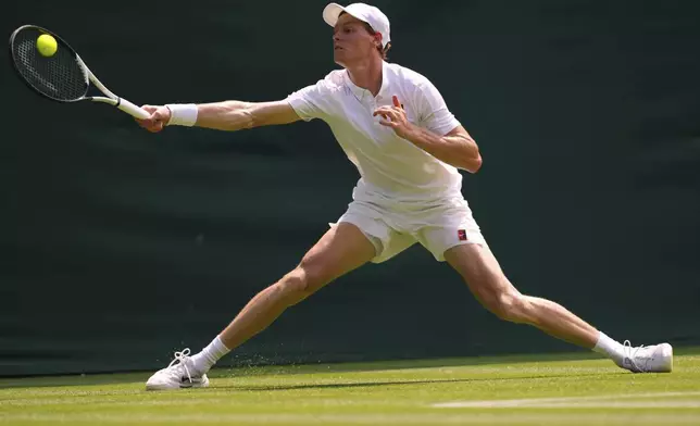 Jannik Sinner of Italy plays a return to Luca Nardi of Italy during their first round men's singles match at the Wimbledon Tennis Championships in London, Tuesday, July 1, 2025.(AP Photo/Kirsty Wigglesworth)