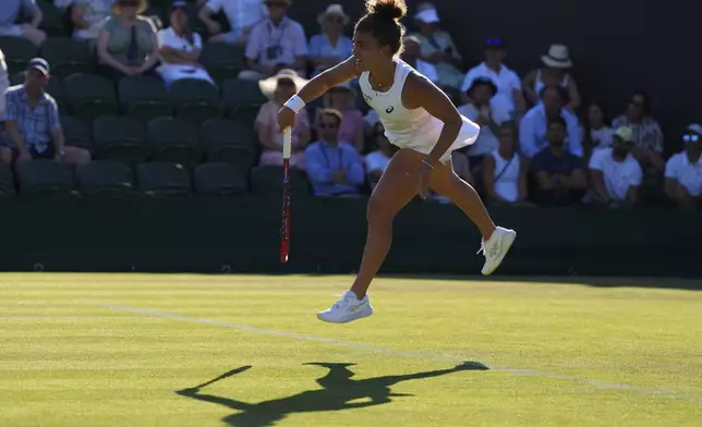Jasmine Paolini of Italy serves the ball during her first round women's single match against Anastasija Sevastova of Latvia at the Wimbledon Tennis Championships in London, Monday, June 30, 2025. (AP Photo/Kirsty Wigglesworth)