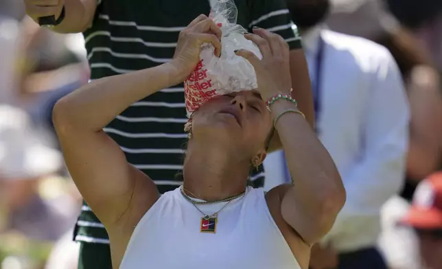 Aryna Sabalenka of Belarus uses an ice pack to cool during her match against Carson Branstine of Canada at their first round women's single match at the Wimbledon Tennis Championships in London, Monday, June 30, 2025. (AP Photo/Kin Cheung)