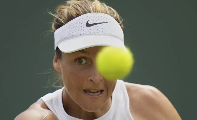 Tatjana Maria of Germany returns to Katie Volynets of the U.S. during their first round women's singles match at the Wimbledon Tennis Championships in London, Tuesday, July 1, 2025. (AP Photo/Alastair Grant)