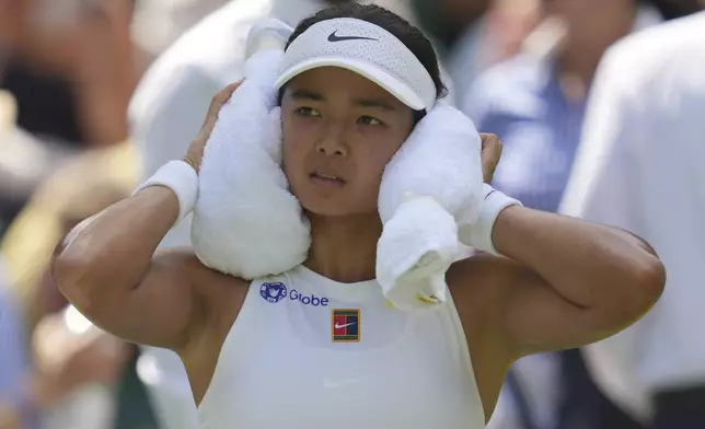 Alexandra Eala of the Philippines tries to keep cool as she plays Barbora Krejcikova of Czech Republic during their first round women's singles match at the Wimbledon Tennis Championships in London, Tuesday, July 1, 2025. (AP Photo/Kin Cheung)