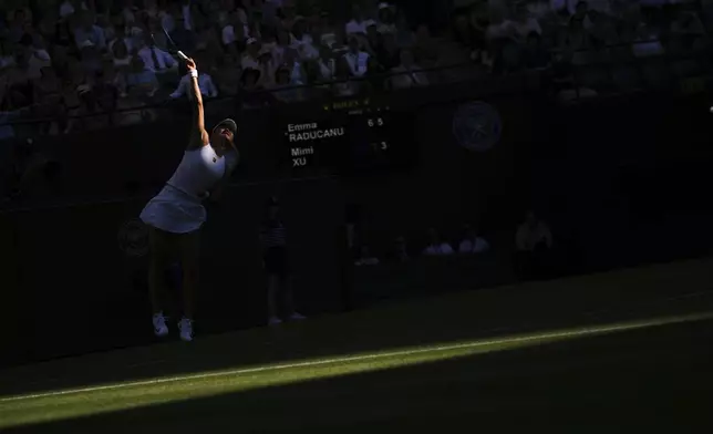 Emma Raducanu of Britain serves the ball during her first round women's single match against Mimi Xu of Britain at the Wimbledon Tennis Championships in London, Monday, June 30, 2025. (AP Photo/Kin Cheung)