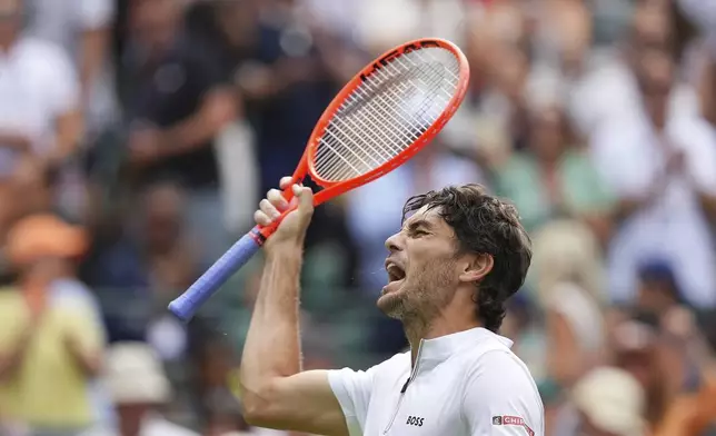 Taylor Fritz of the U.S. celebrates winning the first round men's singles match against Giovanni Mpetshi Perricard of France at the Wimbledon Tennis Championships in London, Tuesday, July 1, 2025.(AP Photo/Kirsty Wigglesworth)