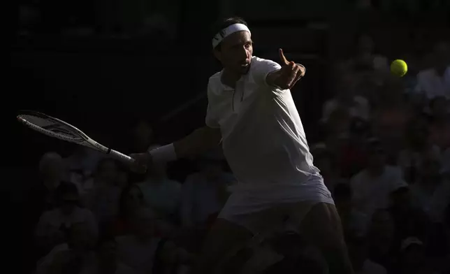 Arthur Rinderknech of France returns to Alexander Zverev of Germany during their first round men's singles match at the Wimbledon Tennis Championships in London, Tuesday, July 1, 2025. (AP Photo/Kin Cheung)