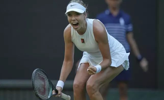 Katie Boulter of Britain celebrates after beating Paula Badosa of Spain during their first round women's singles match at the Wimbledon Tennis Championships in London, Monday, June 30, 2025. (AP Photo/Alastair Grant)