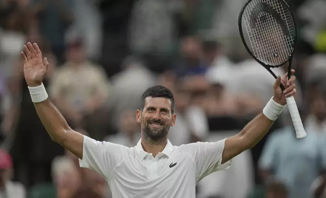 Novak Djokovic of Serbia celebrates after beating Alexandre Muller of France in their first round men's singles match at the Wimbledon Tennis Championships in London, Tuesday, July 1, 2025. (AP Photo/Kin Cheung)