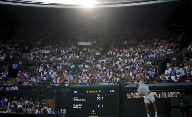 Jack Draper of Britain serves the ball to Sebastian Baez of Argentina during their first round men's single match at the Wimbledon Tennis Championships in London, Tuesday, July 1, 2025.(AP Photo/Kirsty Wigglesworth)