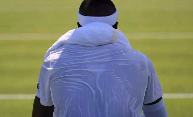 Frances Tiafoe of the U.S. rests during his first round men's single match against Elmer Moller of Denmark at the Wimbledon Tennis Championships in London, Monday, June 30, 2025. (AP Photo/Kirsty Wigglesworth)