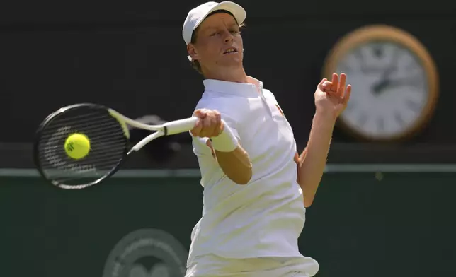 Jannik Sinner of Italy plays a return to Luca Nardi of Italy during their first round men's singles match at the Wimbledon Tennis Championships in London, Tuesday, July 1, 2025.(AP Photo/Kirsty Wigglesworth)