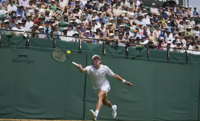 Alex de Minaur of Australia returns to Roberto Carballes Baena of Spain during their first round men's singles match at the Wimbledon Tennis Championships in London, Tuesday, July 1, 2025. (AP Photo/Kin Cheung)
