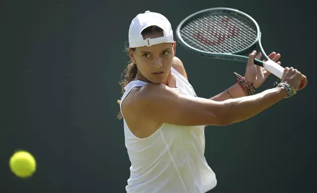 Emiliana Arango of Colombia returns to Daria Kasatkina of Australia during their first round women's singles match at the Wimbledon Tennis Championships in London, Tuesday, July 1, 2025. (AP Photo/Alastair Grant)