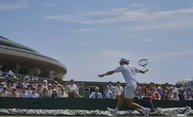 Alex de Minaur of Australia returns to Roberto Carballes Baena of Spain during their first round men's singles match at the Wimbledon Tennis Championships in London, Tuesday, July 1, 2025. (AP Photo/Kin Cheung)