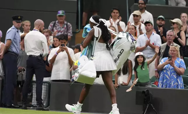 Coco Gauff of the U.S. leaves the court after losing her first round women's single match against Dayana Yastremska of Ukraine at the Wimbledon Tennis Championships in London, Tuesday, July 1, 2025.(AP Photo/Kirsty Wigglesworth)