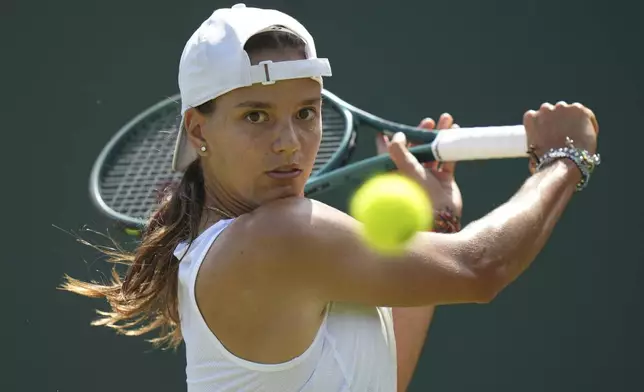 Emiliana Arango of Colombia returns to Daria Kasatkina of Australia during their first round women's singles match at the Wimbledon Tennis Championships in London, Tuesday, July 1, 2025. (AP Photo/Alastair Grant)