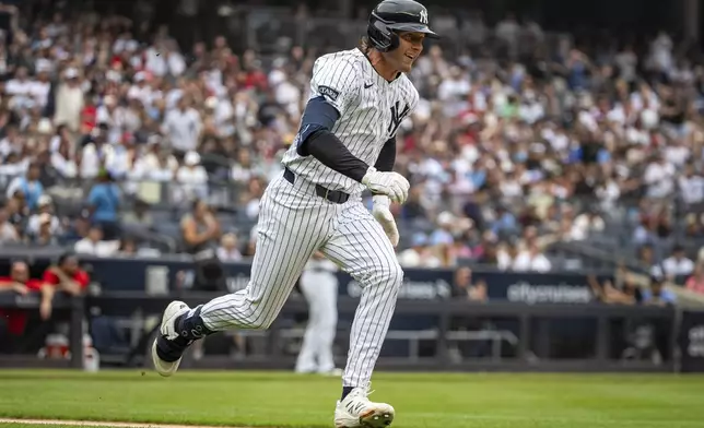 New York Yankees' Ryan McMahon runs after hitting a two-run double during the second inning of a baseball game against the Philadelphia Phillies, Sunday, July 27, 2025, in New York. (AP Photo/Angelina Katsanis)